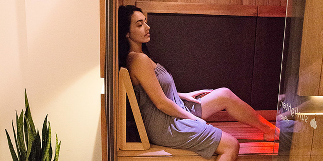 woman relaxing in infrared sauna